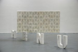 A marble sculpture by artist and sculptor G. Alexandridis, presenting the word "menu". Ένα γλυπτό σε μάρμαρο από τον εικαστικό και γλύπτη Γ. Αλεξανδρίδη.